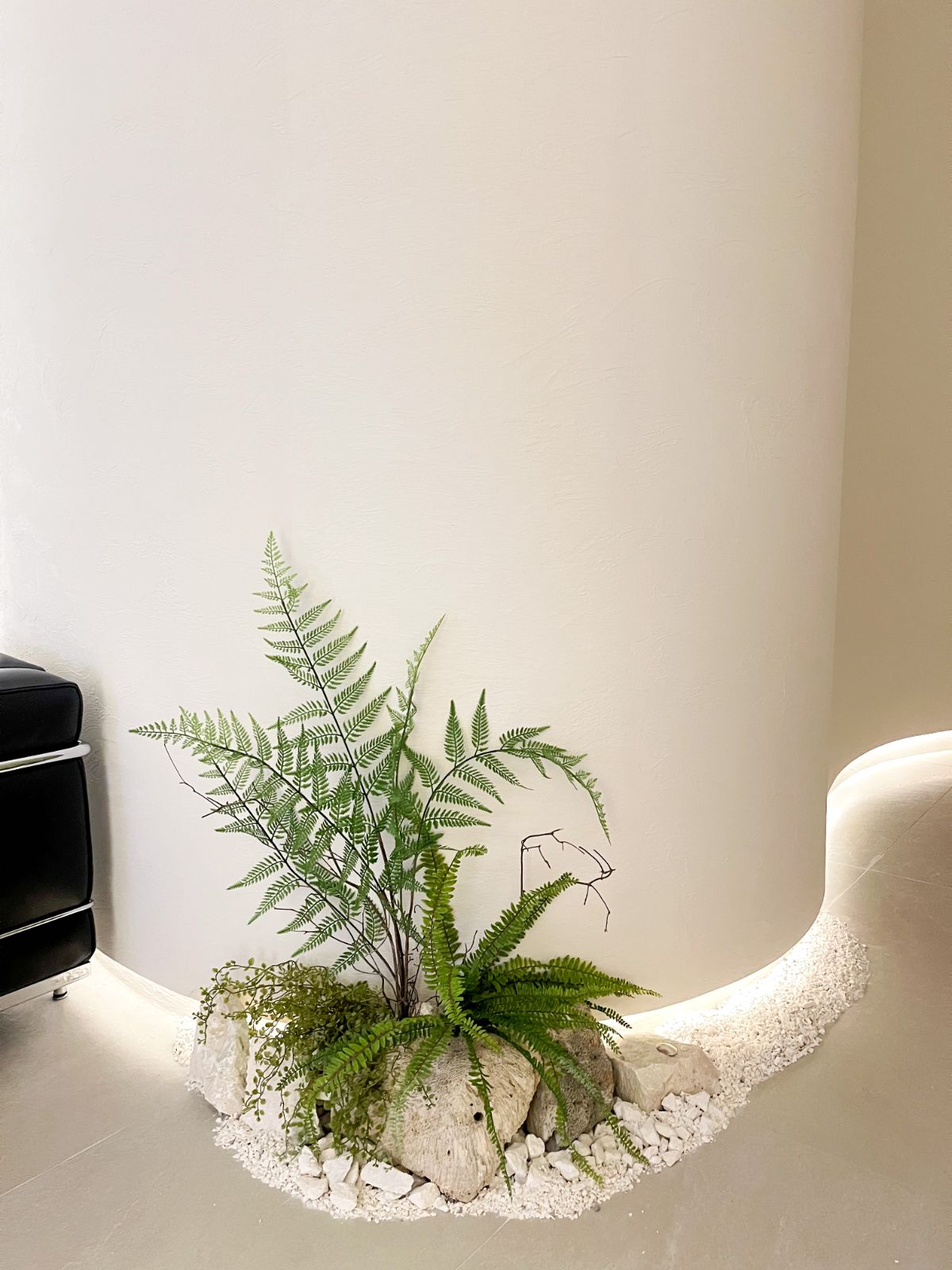 Plot development showroom with stone and fern planting