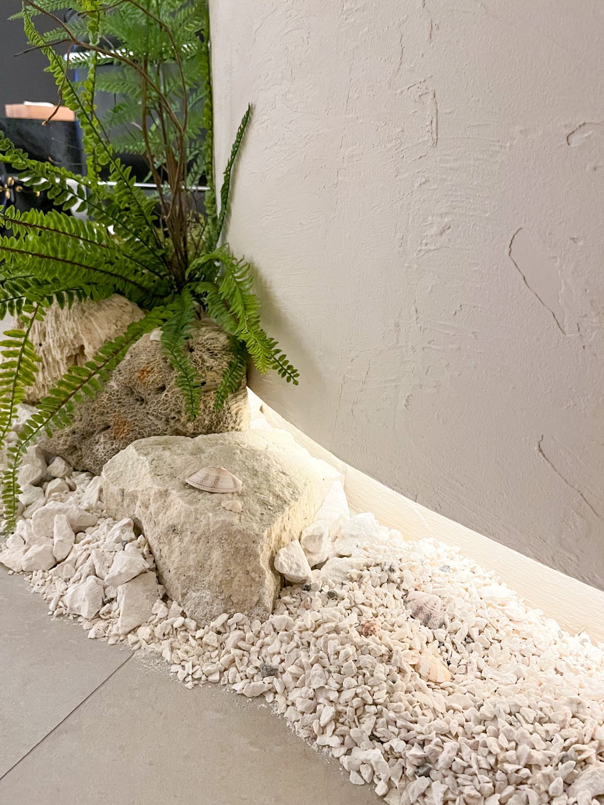 Plot development showroom with stone and fern planting