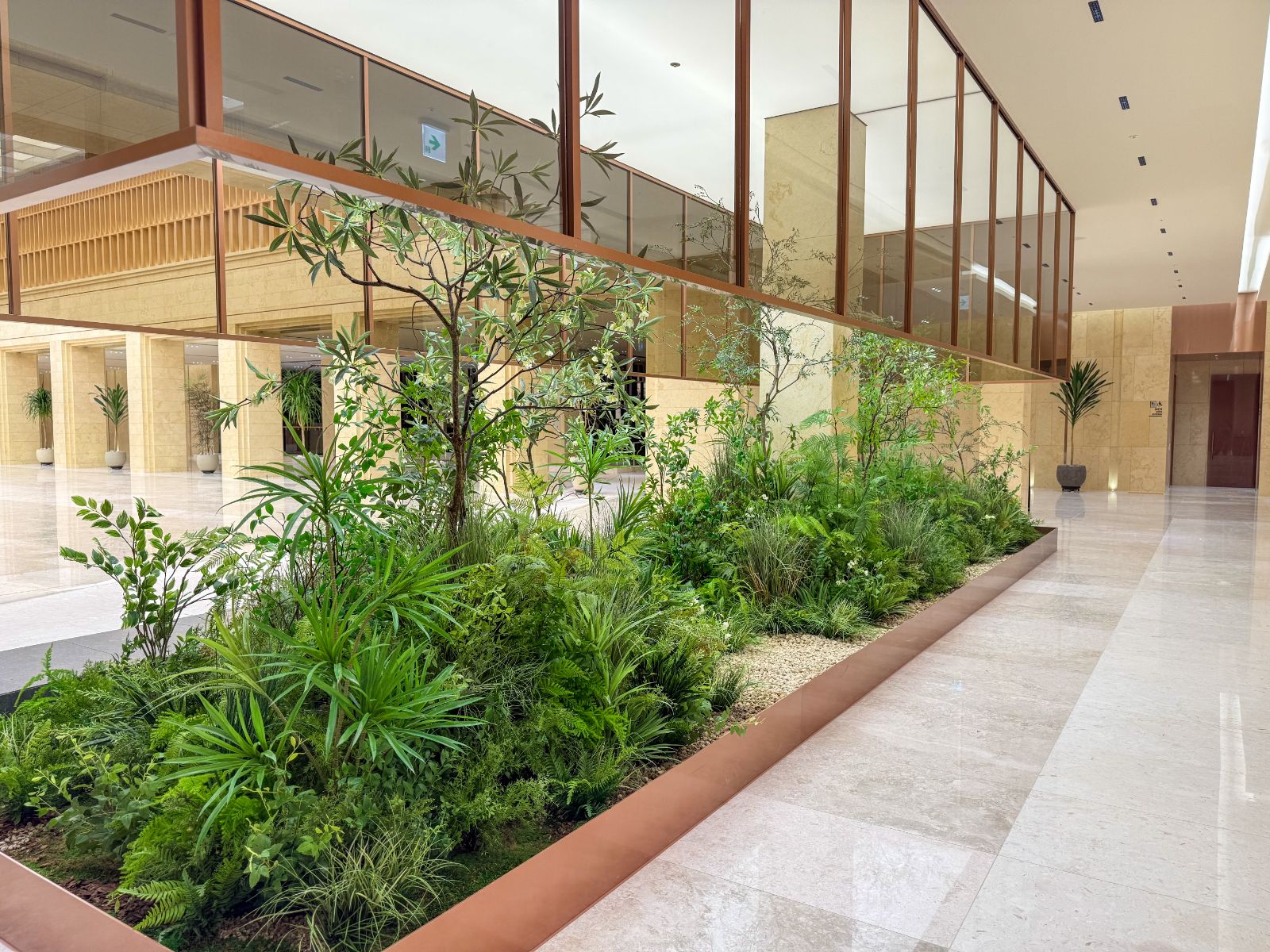 Radomus interior landscaping with ferns and grasses along a lobby planter